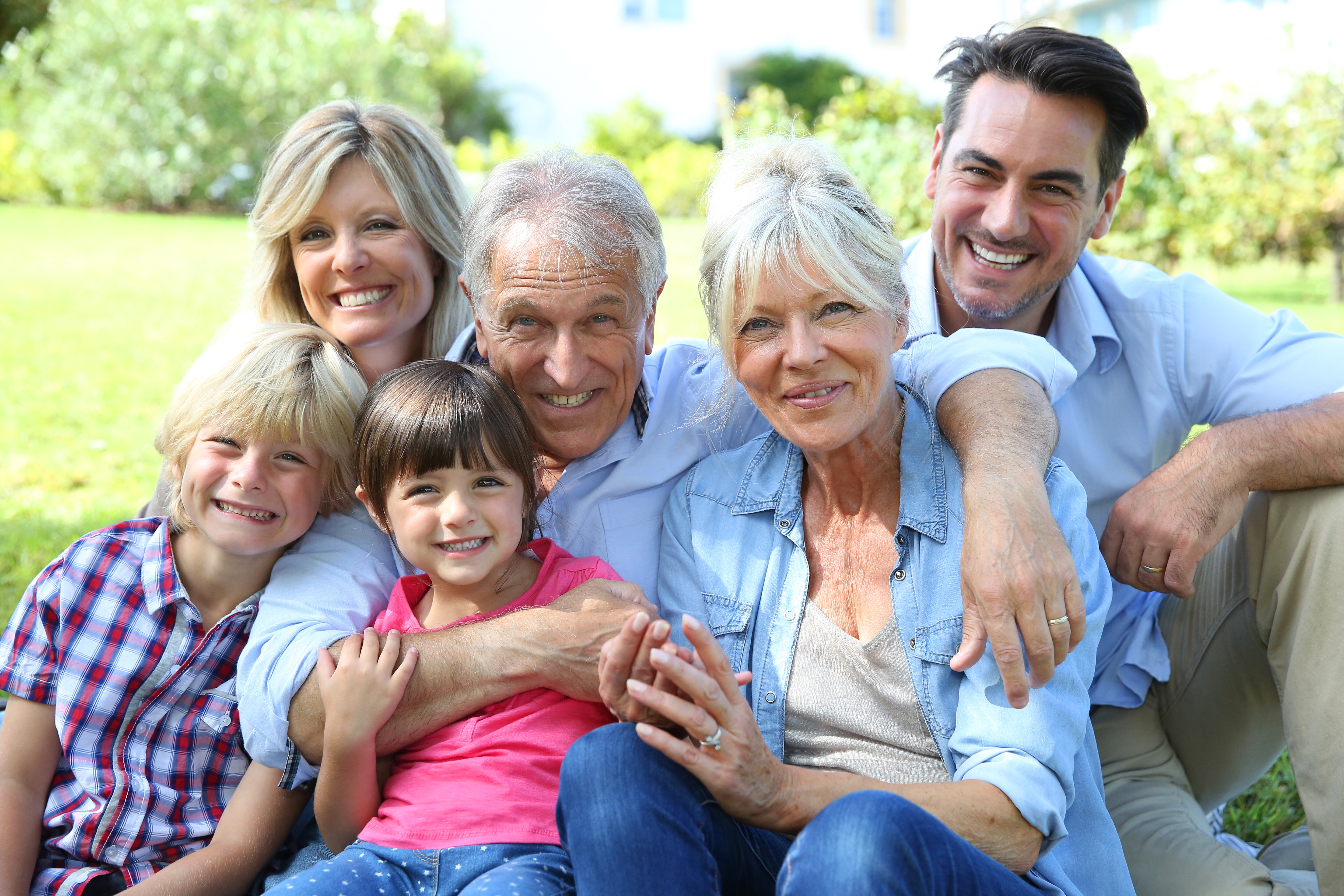 Family Hugging In Park